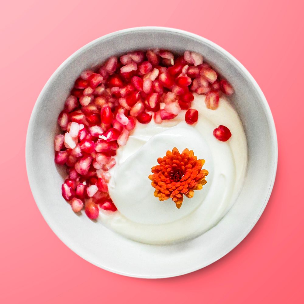 Yogurt with pomegranate in a bowl, food photography, flat lay style
