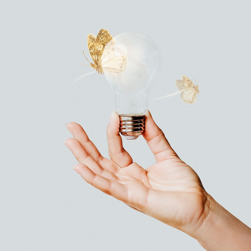 Creative ideas, hand holding light bulb