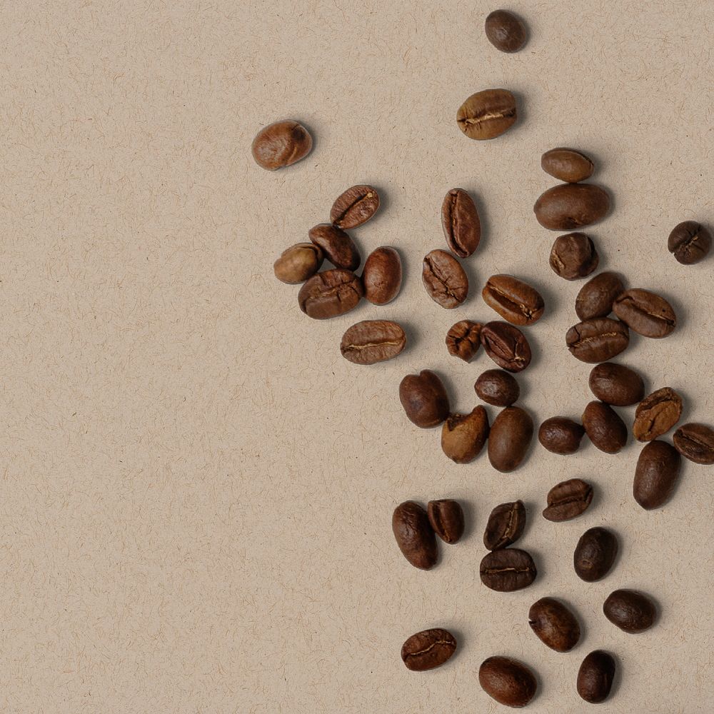 Roasted coffee beans, beige background