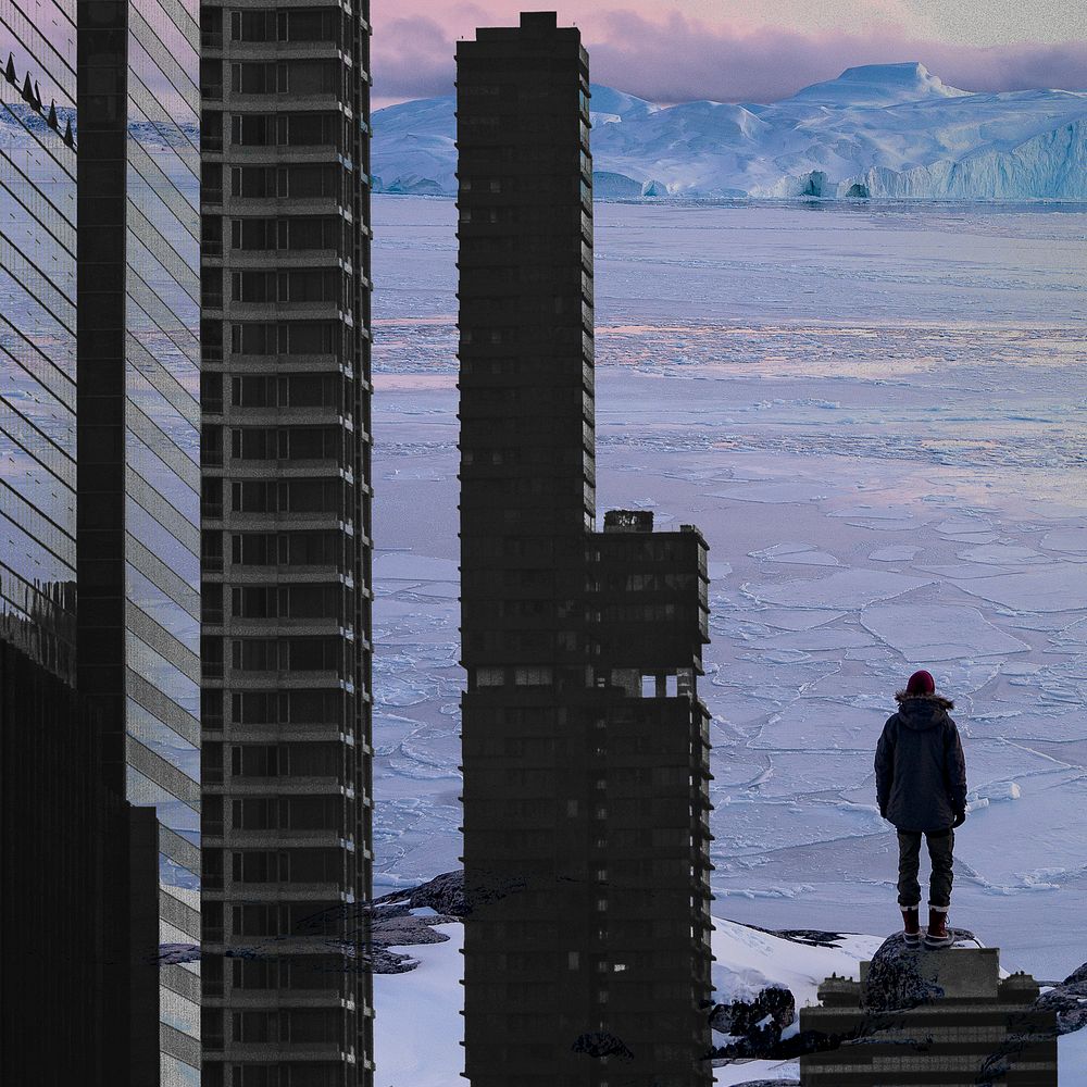 Man standing on top building facing snow mountain