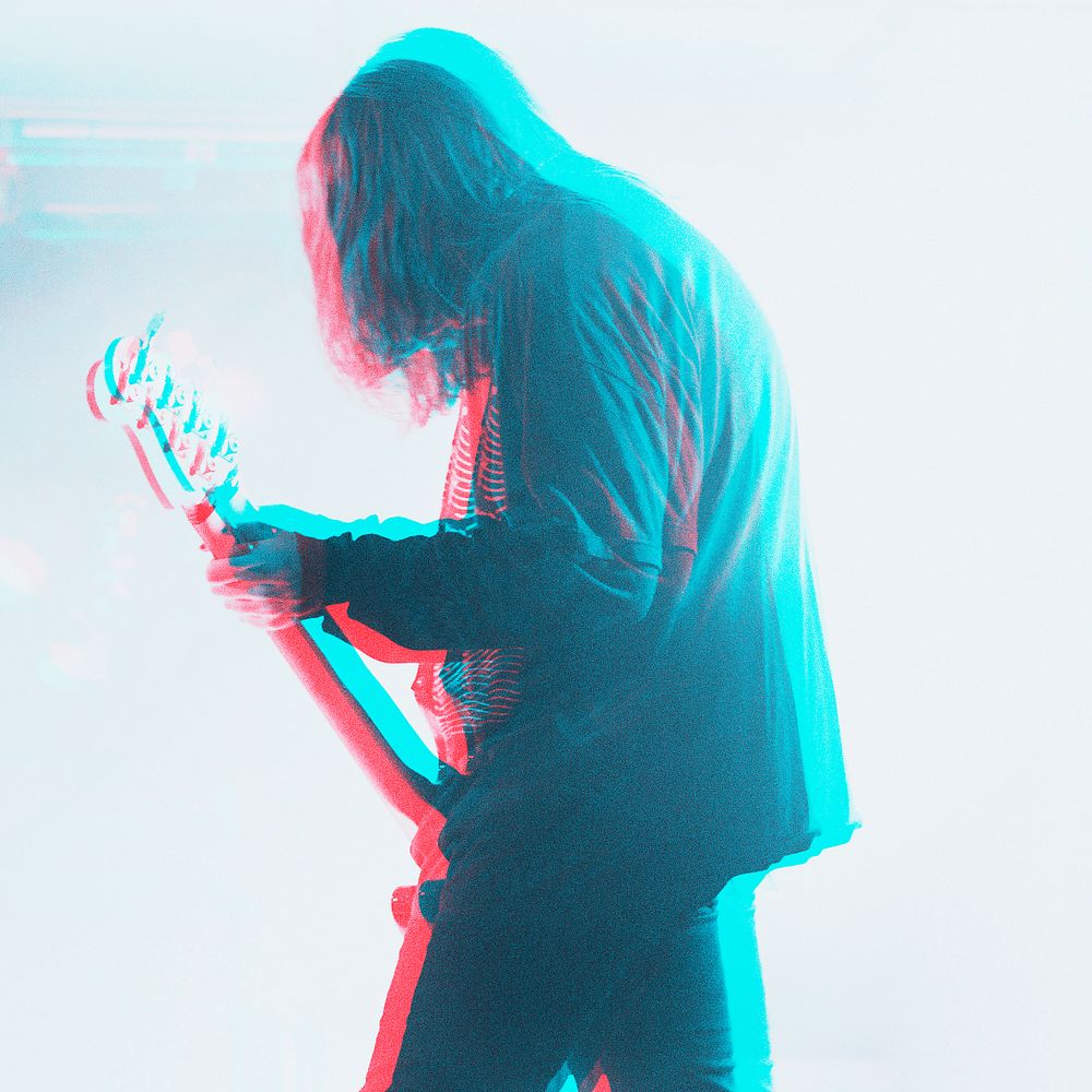 Bassist performing in a concert in double color exposure effect