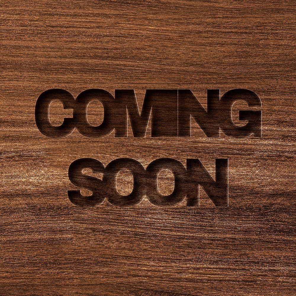 Coming soon engraved wood typography on wooden background