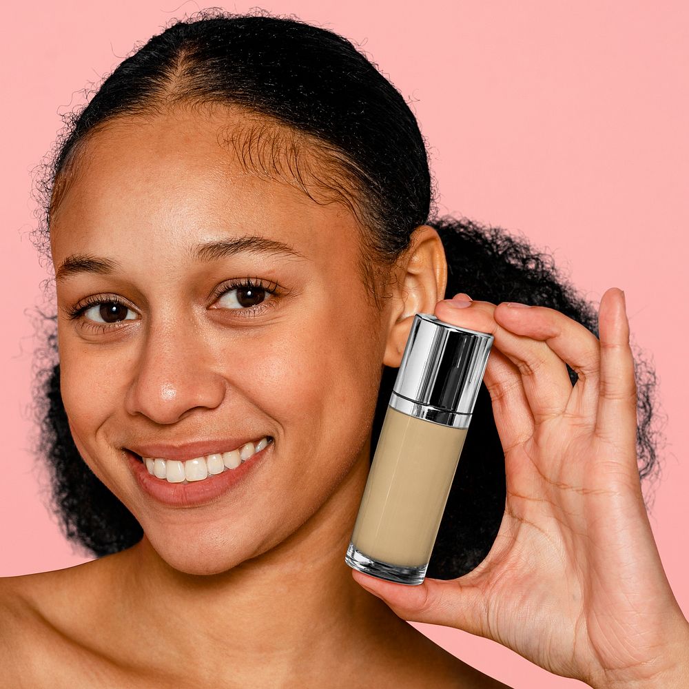 Woman holding foundation bottle, makeup & cosmetics