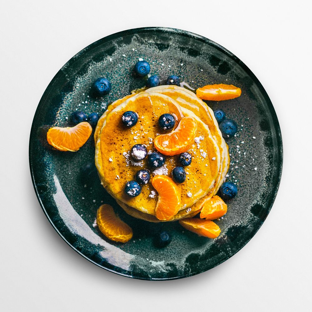 Pancake with fruit on a plate, food photography, flat lay style