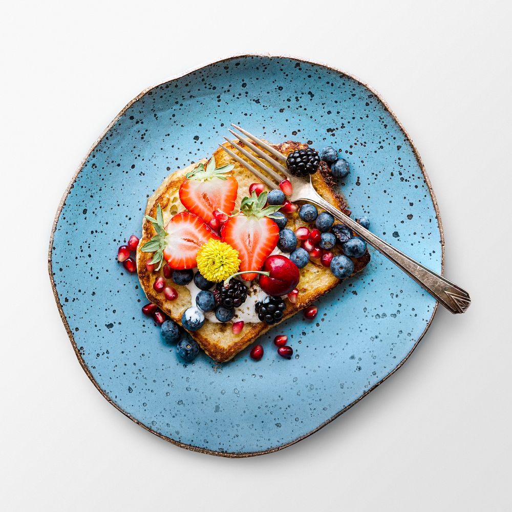 Toast with fruit on a plate, food photography, flat lay style