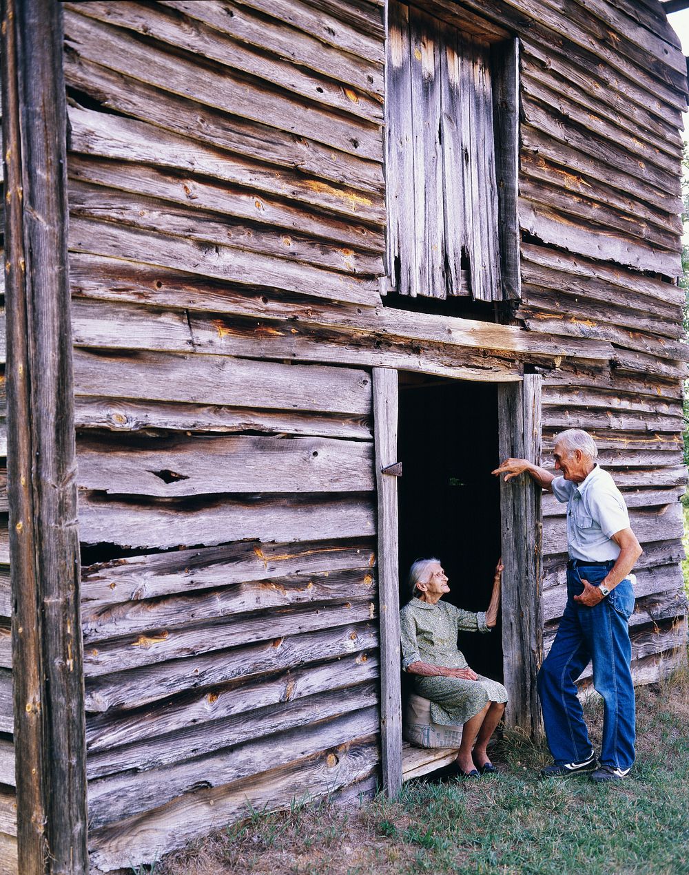 Kate Carter sitting at a barn door on the farm where Carol Highsmith's Grandfather and Great Grandfather were born